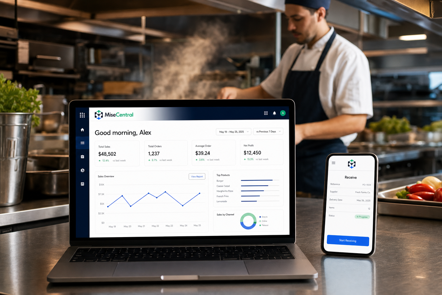 Chef in a commercial kitchen using MiseCentral on a laptop and phone